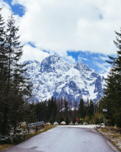 two-tourist-standing-road-near-snowy-mountain